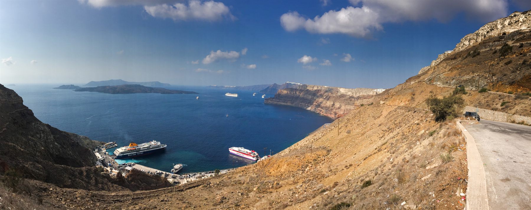 Cruise ships anchored in the Santorini caldera, seen from the clifftop road